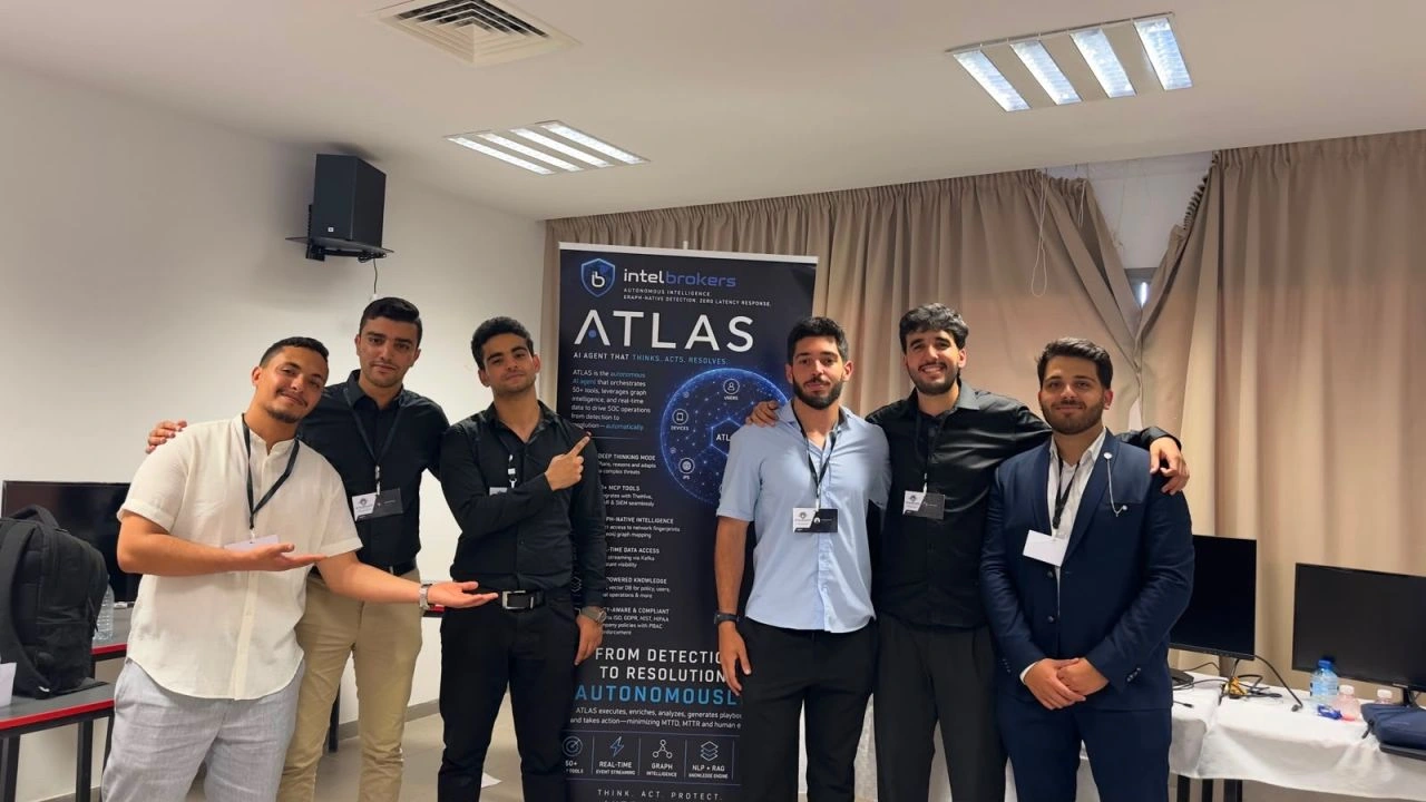 The ATLAS team standing beside their project display.